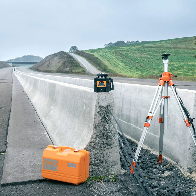Geo Fennel FL 155 H-G Rotating Laser and case and tripod at a road construction site